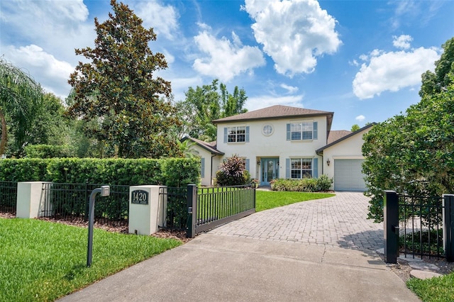 1420 Palmer Ave, Winter Park, FL 32789 - view of front of property with stucco siding, decorative driveway, an attached garage, and a gate
