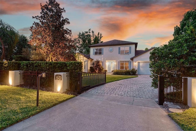 1420 Palmer Ave, Winter Park, FL 32789 - view of front of property with decorative driveway, an attached garage, stucco siding, and a gate