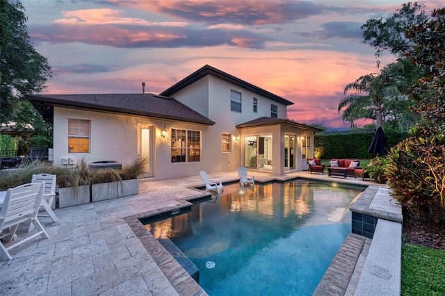1420 Palmer Ave, Winter Park, FL 32789 - back of property at dusk with stucco siding, an outdoor hangout area, and a patio