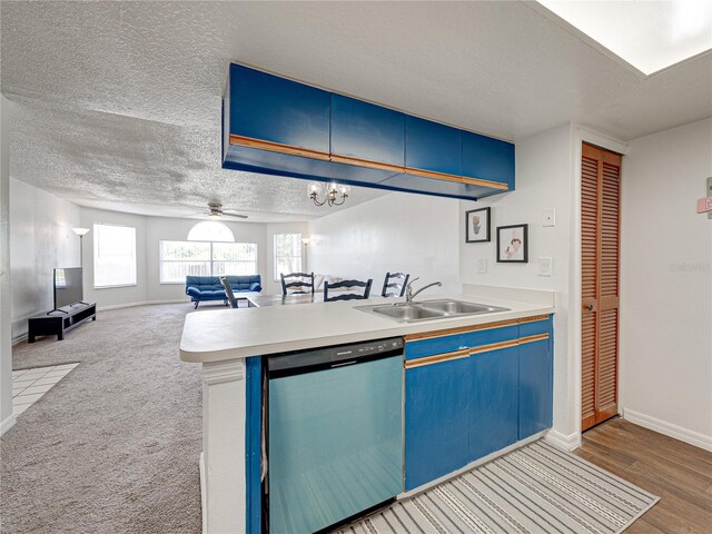 2729 N Poinciana Blvd Unit 125, Kissimmee, FL 34746 - kitchen featuring dishwashing machine, a sink, blue cabinetry, open floor plan, and a textured ceiling
