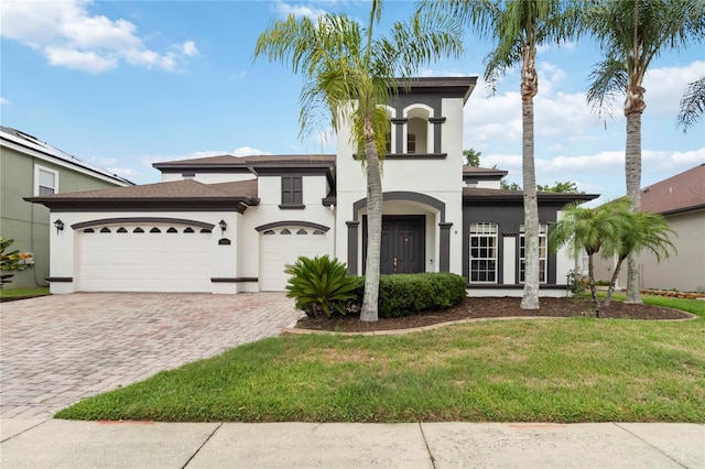1429 Arbitus Cir, Oviedo, FL 32765 - view of front of house with decorative driveway, stucco siding, an attached garage, and a front yard