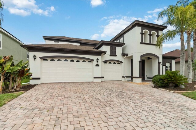 1429 Arbitus Cir, Oviedo, FL 32765 - view of front of house featuring decorative driveway, stucco siding, and a garage