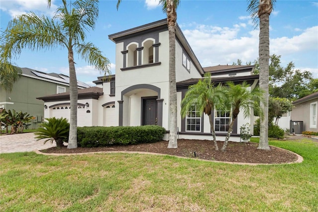 1429 Arbitus Cir, Oviedo, FL 32765 - mediterranean / spanish house with stucco siding, a front lawn, an attached garage, and driveway