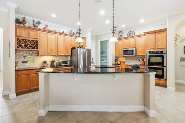 1429 Arbitus Cir, Oviedo, FL 32765 - kitchen with stainless steel appliances, crown molding, backsplash, a kitchen island with sink, and dark countertops