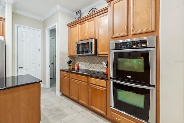 1429 Arbitus Cir, Oviedo, FL 32765 - kitchen with appliances with stainless steel finishes, tasteful backsplash, crown molding, dark stone counters, and baseboards