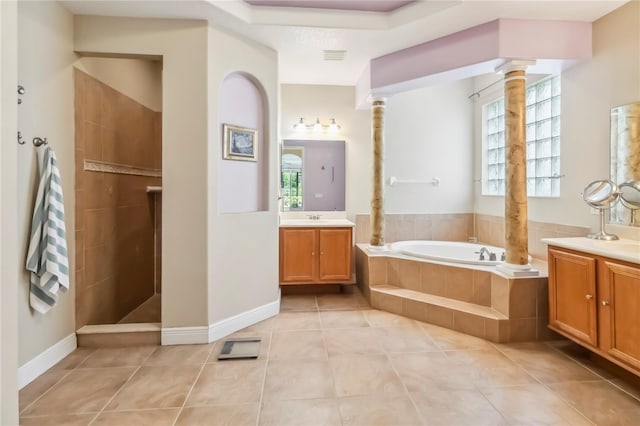 1429 Arbitus Cir, Oviedo, FL 32765 - bathroom with decorative columns, a garden tub, plenty of natural light, and two vanities