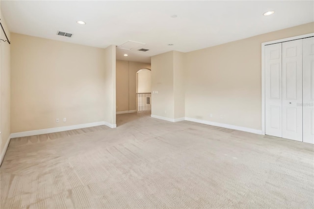 1429 Arbitus Cir, Oviedo, FL 32765 - unfurnished bedroom featuring light colored carpet, arched walkways, recessed lighting, baseboards, and a closet