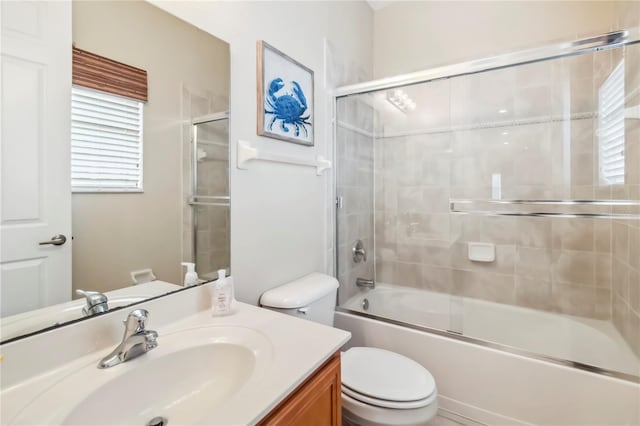 1429 Arbitus Cir, Oviedo, FL 32765 - bathroom featuring toilet, vanity, and combined bath / shower with glass door