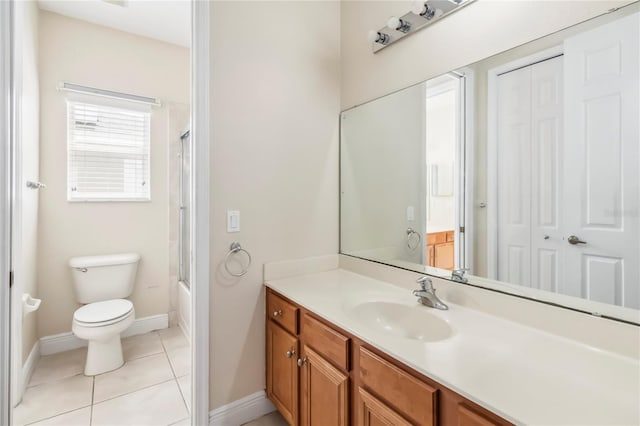 1429 Arbitus Cir, Oviedo, FL 32765 - full bath featuring vanity, toilet, baseboards, tile patterned floors, and shower / bath combination with glass door