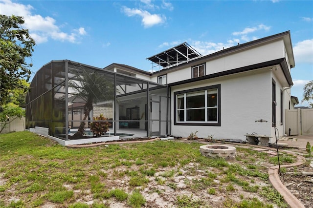1429 Arbitus Cir, Oviedo, FL 32765 - rear view of property with a fire pit, stucco siding, a lawn, a swimming pool, and glass enclosure