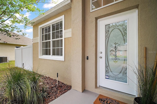 2306 Valhalla Dr, Tavares, FL 32778 - doorway to property featuring central AC and stucco siding