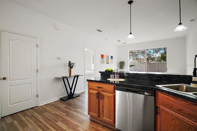 2306 Valhalla Dr, Tavares, FL 32778 - kitchen featuring stainless steel dishwasher, dark wood-style flooring, brown cabinetry, and pendant lighting