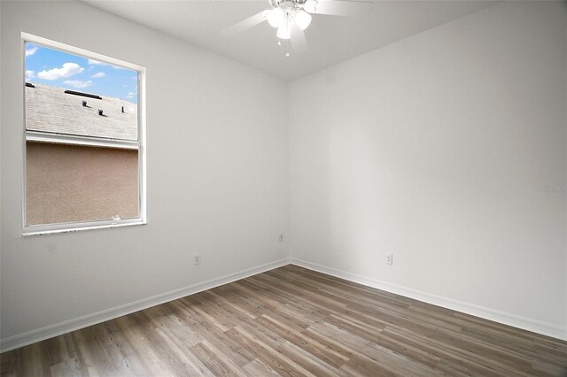 2306 Valhalla Dr, Tavares, FL 32778 - unfurnished room with wood finished floors, a ceiling fan, and baseboards