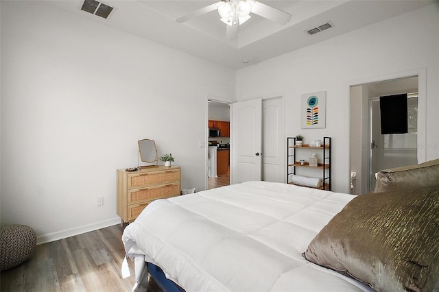 2306 Valhalla Dr, Tavares, FL 32778 - bedroom featuring wood finished floors, baseboards, a high ceiling, ceiling fan, and connected bathroom