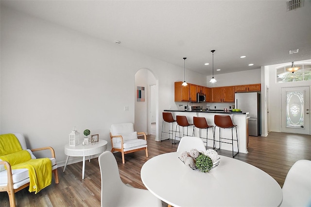 2306 Valhalla Dr, Tavares, FL 32778 - dining room with arched walkways, dark wood-style flooring, recessed lighting, and baseboards