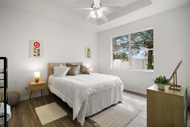 2306 Valhalla Dr, Tavares, FL 32778 - bedroom with wood finished floors, baseboards, a raised ceiling, and ceiling fan