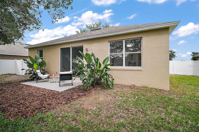 2306 Valhalla Dr, Tavares, FL 32778 - back of house with stucco siding, a fenced backyard, and a patio