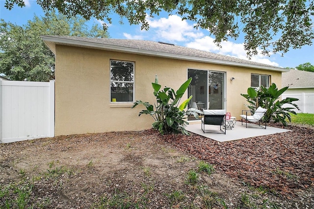 2306 Valhalla Dr, Tavares, FL 32778 - back of house featuring stucco siding and a patio