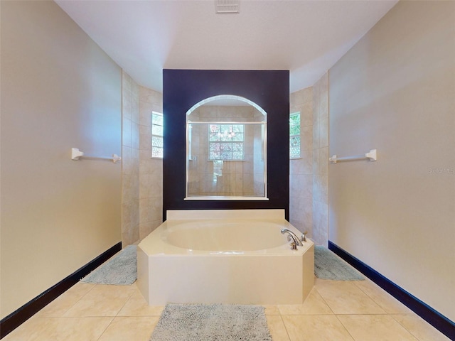 3216 Rolling Hills Ln, Apopka, FL 32712 - full bath featuring tile patterned flooring, a garden tub, baseboards, and a walk in shower