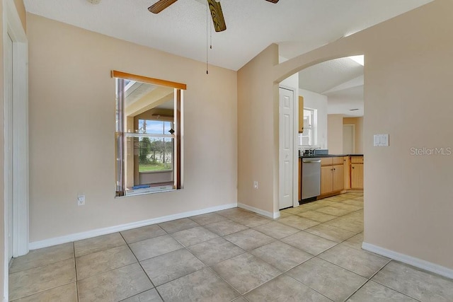 2772 Pelham Cir, Deltona, FL 32738 - empty room featuring arched walkways, a ceiling fan, light tile patterned floors, and baseboards