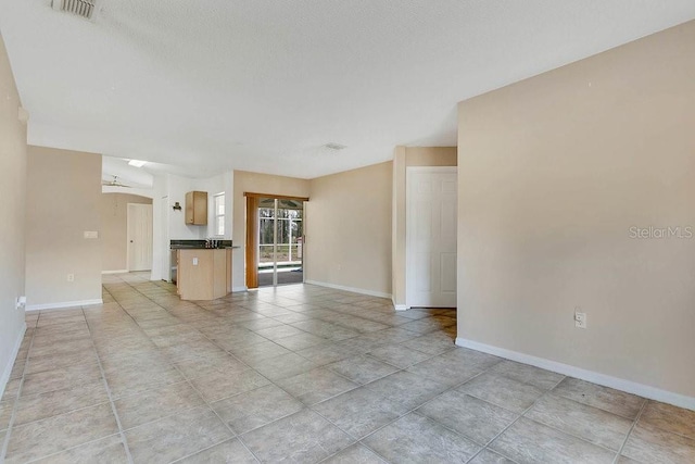 2772 Pelham Cir, Deltona, FL 32738 - unfurnished living room with baseboards and light tile patterned floors