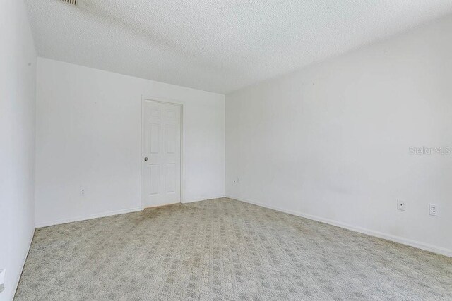 2772 Pelham Cir, Deltona, FL 32738 - unfurnished room with carpet floors and a textured ceiling