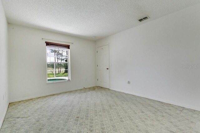 2772 Pelham Cir, Deltona, FL 32738 - carpeted spare room with a textured ceiling and baseboards