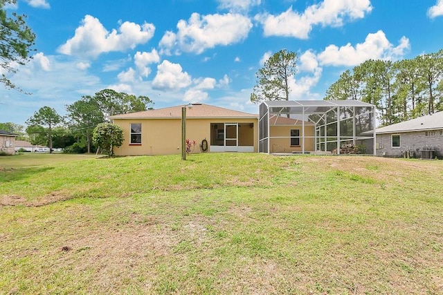 2772 Pelham Cir, Deltona, FL 32738 - rear view of property featuring a yard, glass enclosure, and central AC