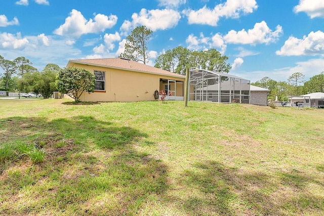 2772 Pelham Cir, Deltona, FL 32738 - rear view of house featuring a yard, glass enclosure, and stucco siding