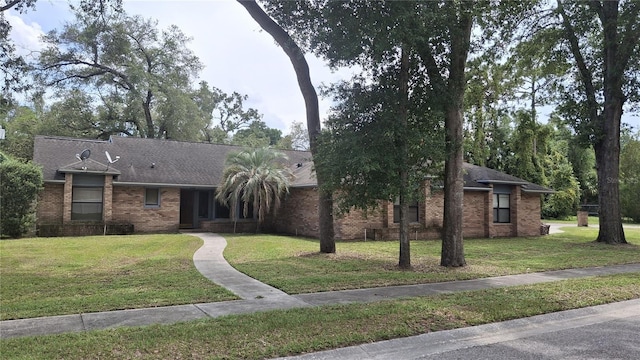 900 Red Fox Rd, Altamonte Springs, FL 32714 - view of front of home featuring a front lawn, brick siding, and a shingled roof