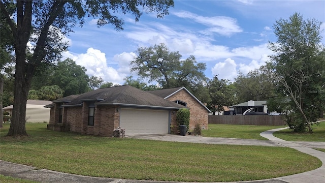 900 Red Fox Rd, Altamonte Springs, FL 32714 - view of side of property with an attached garage, driveway, and brick siding