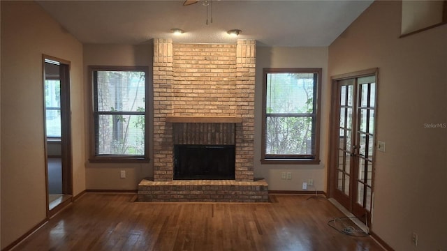 900 Red Fox Rd, Altamonte Springs, FL 32714 - unfurnished living room with baseboards, wood finished floors, and a brick fireplace