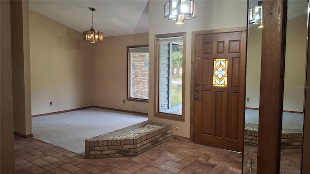900 Red Fox Rd, Altamonte Springs, FL 32714 - carpeted entryway with baseboards, a chandelier, lofted ceiling, and brick patterned floors
