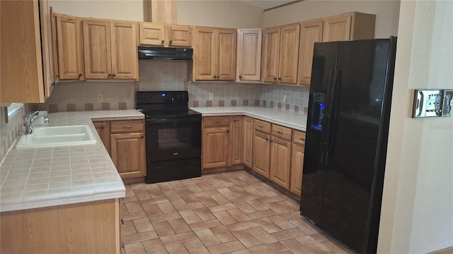 900 Red Fox Rd, Altamonte Springs, FL 32714 - kitchen with black appliances, a sink, tile countertops, under cabinet range hood, and backsplash