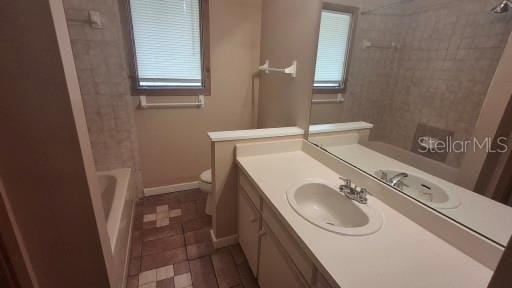 900 Red Fox Rd, Altamonte Springs, FL 32714 - full bathroom featuring toilet, vanity, tile patterned floors, baseboards, and washtub / shower combination
