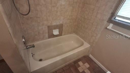 900 Red Fox Rd, Altamonte Springs, FL 32714 - bathroom featuring baseboards and  shower combination