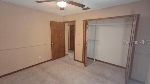 900 Red Fox Rd, Altamonte Springs, FL 32714 - unfurnished bedroom featuring a closet, a ceiling fan, light carpet, and baseboards