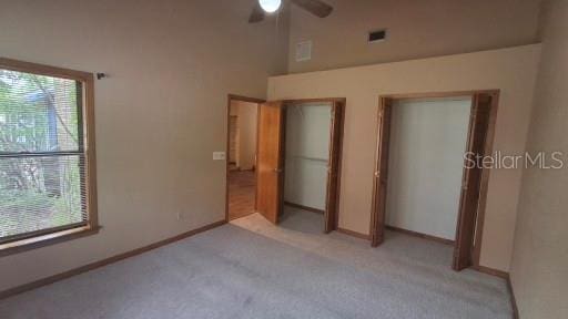 900 Red Fox Rd, Altamonte Springs, FL 32714 - unfurnished bedroom with two closets, light carpet, multiple windows, and baseboards
