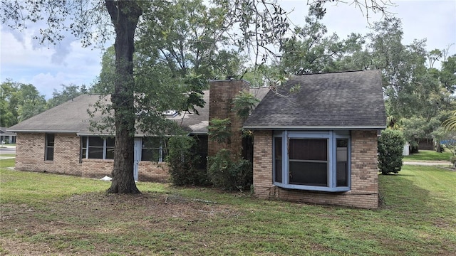 900 Red Fox Rd, Altamonte Springs, FL 32714 - view of front of home with brick siding, a front lawn, and roof with shingles