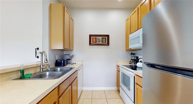 2411 Caravelle Cir, Kissimmee, FL 34746 - kitchen with white appliances, light countertops, a sink, light tile patterned floors, and baseboards