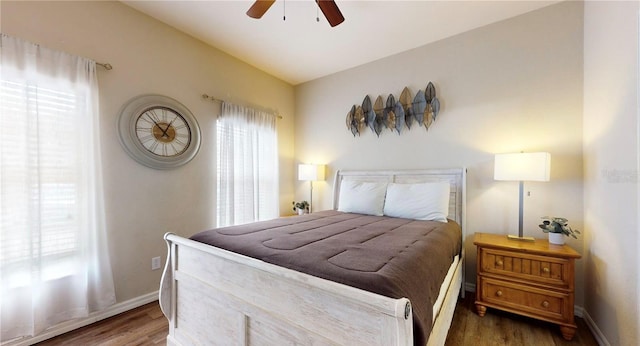 2411 Caravelle Cir, Kissimmee, FL 34746 - bedroom featuring wood finished floors, baseboards, and a ceiling fan