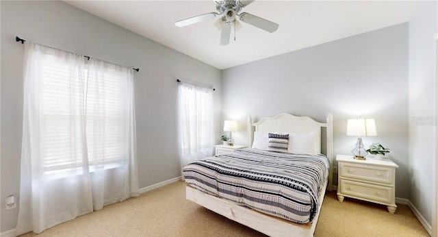 2411 Caravelle Cir, Kissimmee, FL 34746 - bedroom featuring light carpet, baseboards, and a ceiling fan