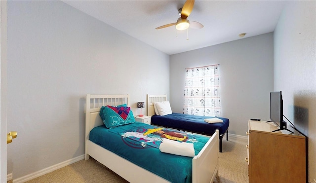 2411 Caravelle Cir, Kissimmee, FL 34746 - bedroom with light carpet, baseboards, and a ceiling fan