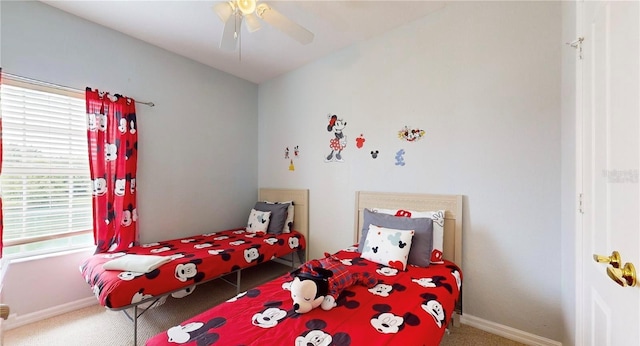 2411 Caravelle Cir, Kissimmee, FL 34746 - carpeted bedroom with baseboards and a ceiling fan
