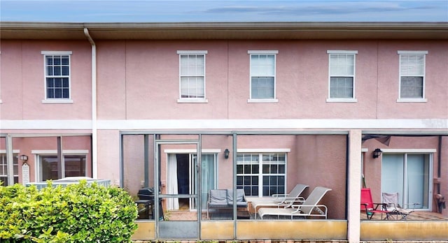 2411 Caravelle Cir, Kissimmee, FL 34746 - rear view of property with stucco siding and a patio area
