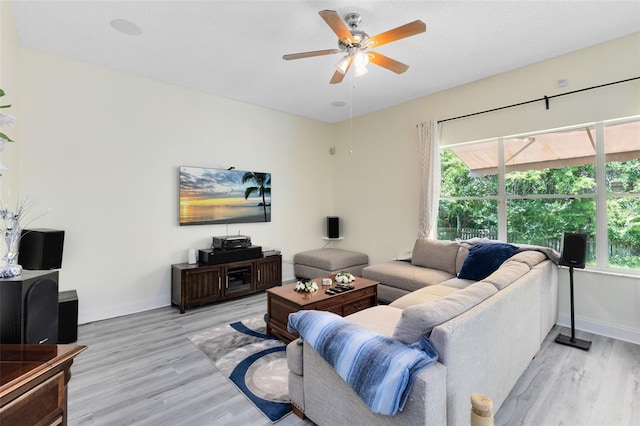10743 Fairhaven Way, Orlando, FL 32825 - living room featuring plenty of natural light, light wood-style floors, and baseboards