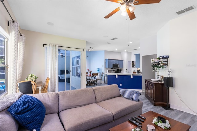 10743 Fairhaven Way, Orlando, FL 32825 - living area with a ceiling fan, light wood finished floors, and baseboards