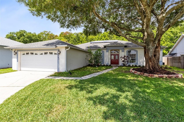 10743 Fairhaven Way, Orlando, FL 32825 - ranch-style house with a garage, roof mounted solar panels, stucco siding, concrete driveway, and a shingled roof