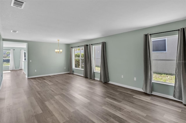 126 San Carlo Rd, Davenport, FL 33896 - spare room featuring a chandelier, plenty of natural light, wood finished floors, and baseboards