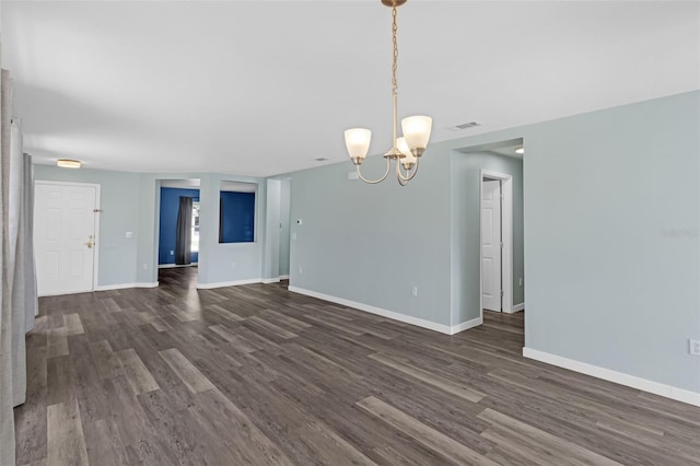 126 San Carlo Rd, Davenport, FL 33896 - unfurnished living room featuring dark wood finished floors, a chandelier, and baseboards
